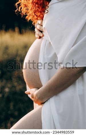 Pregnant girl holding her belly