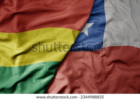 big waving realistic national colorful flag of bolivia and national flag of chile . macro