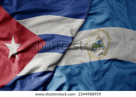 big waving realistic national colorful flag of cuba and national flag of nicaragua macro