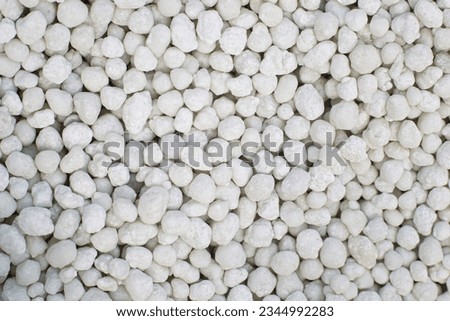 Macro image of white granular chemical fertilizer for plants. Royalty-Free Stock Photo #2344992283