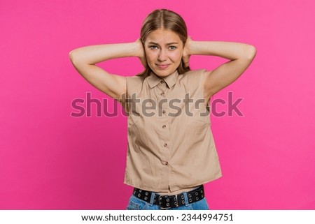 Dont want to hear and listen. Frustrated annoyed irritated woman covering ears gesturing No, avoiding advice ignoring unpleasant noise loud voices. Blonde girl isolated alone on pink background Royalty-Free Stock Photo #2344994751