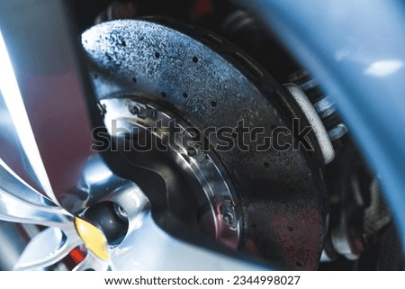 Ceramic disc brakes - Car braking system. Sport car front wheel disc brake. High quality photo Royalty-Free Stock Photo #2344998027