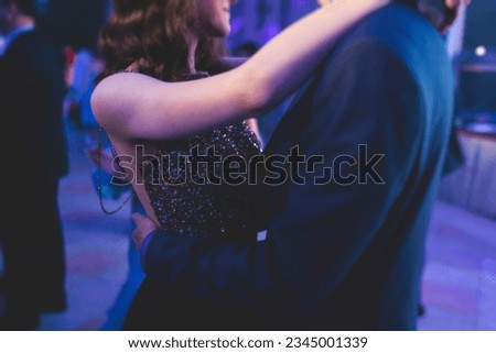 High school graduates dancing waltz and classical ball dance in dresses and suits on a school prom graduation, classical ballroom dancers dancing, waltz, couples quadrille and polonaise Royalty-Free Stock Photo #2345001339