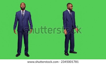 Young businessman expressing i dont know sign in studio and posing over full body green screen. Male company manager wearing office suit feeling confused, being uncertain or unsure on camera.