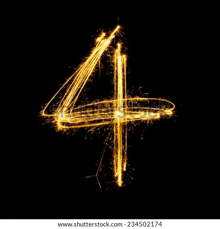 Sparkler firework light alphabet number 4 isolated on black background.