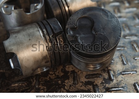 damaged pistons, engine pistons on a work table, disassembled engine, damaged engine, mechanical workshop Royalty-Free Stock Photo #2345022427