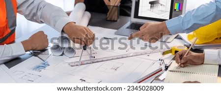 Architect or engineer working on building blueprint, contractor designing and drawing blueprint layout with tool for construction project. Civil engineer and architecture design concept. Insight Royalty-Free Stock Photo #2345028009