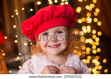 beautiful  smiling  little blonde girl  in red beret on christmas lights background fresh trendy joy happy look cute studio impressions lady