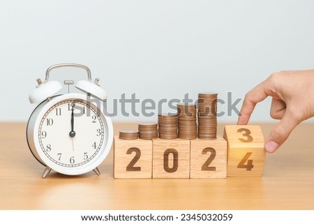 Happy New Year with vintage alarm clock and flipping 2023 change to 2024 block. Resolution, Goals, Plan, Action, Money Saving, Retirement fund, Pension, Investment and Financial concept Royalty-Free Stock Photo #2345032059