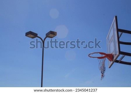 Worn out Basketball Hoop with Background Lamp post Royalty-Free Stock Photo #2345041237