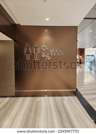Various signs for restrooms and toilets at a department store