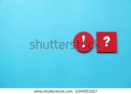 Concept of uncertainty, urgency, importance, inquiry, faq, questions and answers. Exclamation mark and question mark symbol on red wooden square and circle. Copy space.