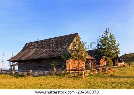 Shepherd wooden hut on meadow in autumn season