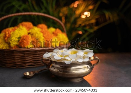 Flowers in a golden vessel. Onam and Diwali festival concept image Royalty-Free Stock Photo #2345094031