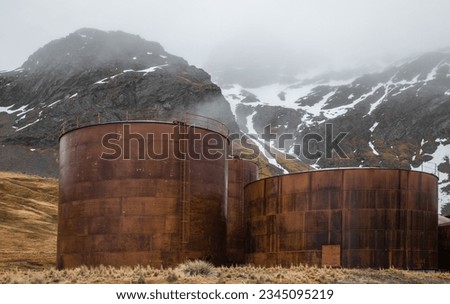 Oil tanks and mountains, in mist; Grytviken, South Georgia; Orange tanks, with mountain backdrop; Grytviken, South Georgia