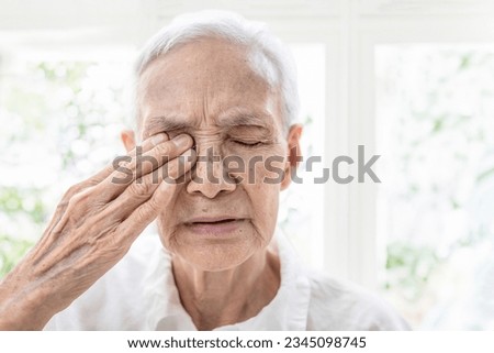 Old elderly suffer from age-related macular degeneration,optic nerve damage,Glaucoma symptoms,painful around the eye area,problem of pressure within the eyeball,vision disturbances or loss of sight Royalty-Free Stock Photo #2345098745