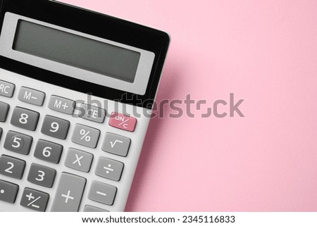 Calculator on pink background, top view. Space for text