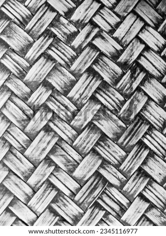 a photography of a black and white photo of a woven basket, a close up of a woven basket with a black and white background.