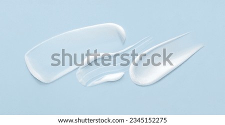 cosmetic smears cream texture on pastel background Royalty-Free Stock Photo #2345152275