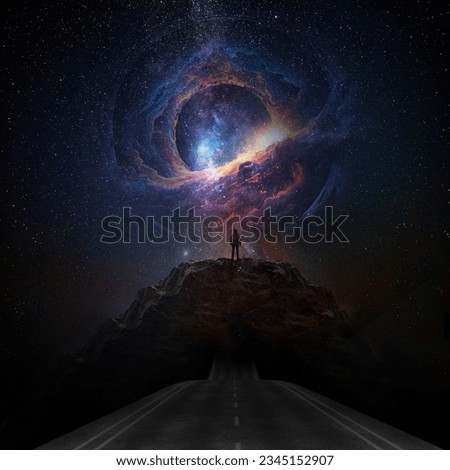 A road leading to distance in a mountain valley with milky way background. Royalty-Free Stock Photo #2345152907