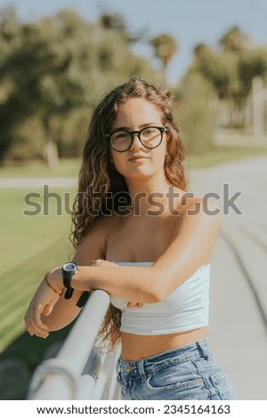 Young woman smiling and modeling for photos. Fashion and lifestyle photography.