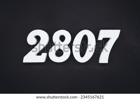 Black for the background. The number 2807 is made of white painted wood.