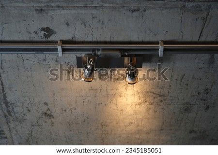 A set of ceiling lights installed on the cement ceiling.