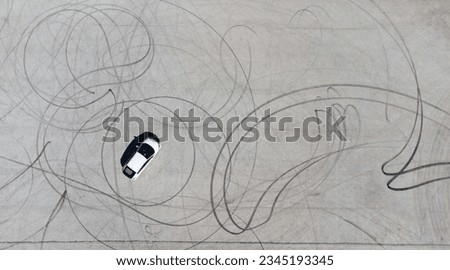 drone picture of a car after drifting and making circles on a road Royalty-Free Stock Photo #2345193345