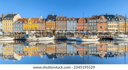 Nyhavn in the city heart of Copenhagen was once a busy trading port. In the morning you can enjoy the silence on the waterfront and the reflection of the calm water looks simply marvelous. Royalty-Free Stock Photo #2345195529