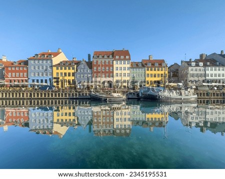 Nyhavn in the city heart of Copenhagen was once a busy trading port. In the morning you can enjoy the silence on the waterfront and the reflection of the calm water looks simply marvelous. Royalty-Free Stock Photo #2345195531