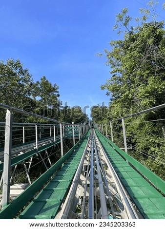 On the way up to the hill by Alphine Coaster Royalty-Free Stock Photo #2345203363
