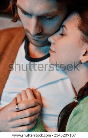 Vertical closeup of young couple cuddling affectionately enjoying time together at home Royalty-Free Stock Photo #2345209107