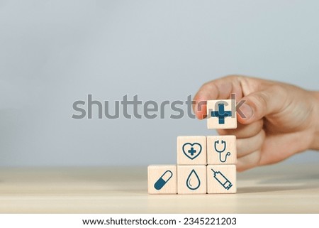 Wooden block with concept of health care, medical icons
