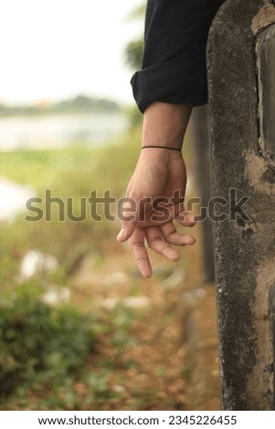 Someone's hand that wants to reach something is like losing hope Royalty-Free Stock Photo #2345226455