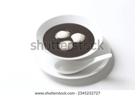 chef cook thick black sesame sweet soup with peanut glutinous rice ball 3pcs tang yuan in white bowl hot sweet asian festive traditional dessert halal food vegan menu for Hong Kong cafe Royalty-Free Stock Photo #2345232727