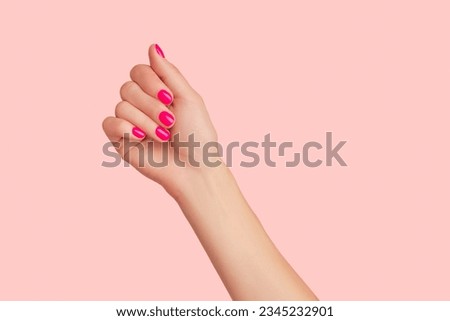 Womans hand with trendy manicure on pastel pink background. Beauty salon concept Royalty-Free Stock Photo #2345232901