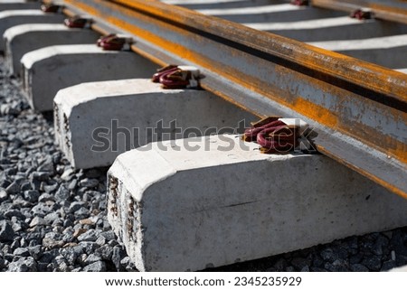 Anchor intermediate rail fastenings. Modern fastening of rails to a sleeper on a railway track Royalty-Free Stock Photo #2345235929
