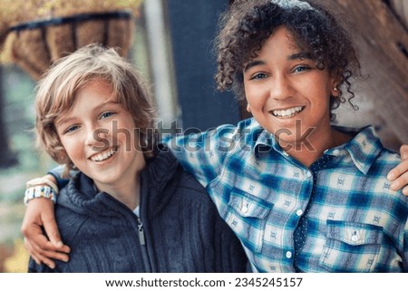 Mixed race group of two happy children, African American biracial girl caucasian boy laughing together Royalty-Free Stock Photo #2345245157