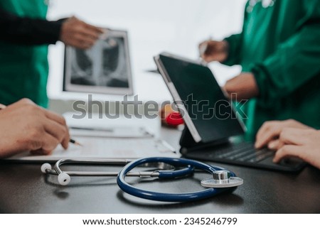 Medical team meeting with doctors in white lab coats and surgical gowns sitting at table discussing patient history. success of medical health care The concept of working with a doctor. Close up.	