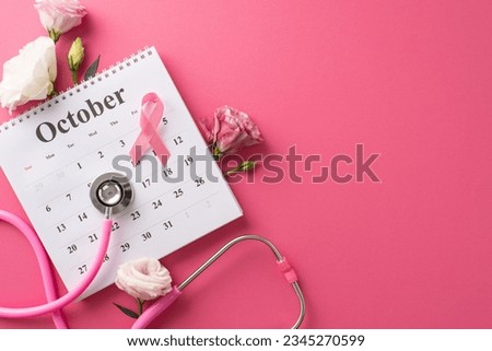 Raising awareness for Breast Cancer Awareness Month. Top view picture featuring a calendar, stethoscope, and pink ribbon on a bright pink isolated background, suitable for text or advertising