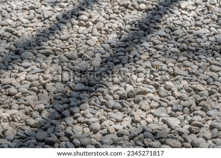 Small volcanic stones are evenly arranged on the lawn to cover the ground which will give a clean and tidy effect.
