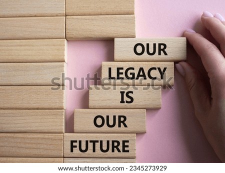 Our Legacy is our Future symbol. Concept words Our Legacy is our Future on wooden blocks. Businessman hand. Beautiful pink background. Business concept. Copy space
