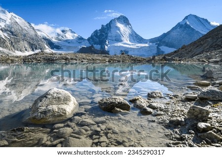 Dent Blanche and reflection in a glacial lake in Val d'Anniviers, Valais Royalty-Free Stock Photo #2345290317