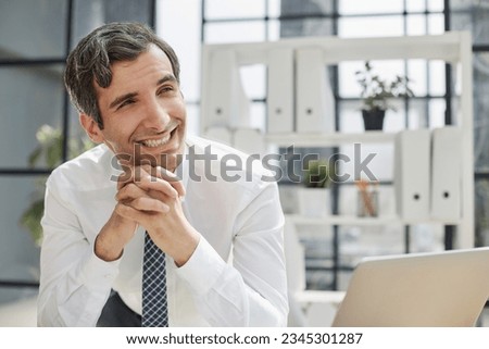 Image of successful businessman 30s thinking and holding index finger at forehead