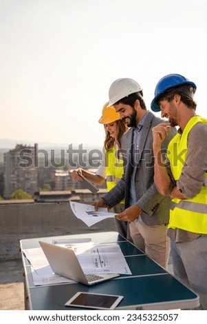 Construction concept. Engineers and architects working at construction site with blueprint