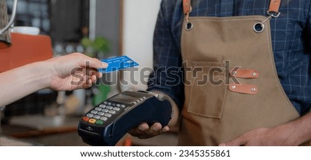 Woman use credit card pay money online in cafe restaurant with a digital payment without cash. accumulate discount. E wallet, technology, pay online, credit card, bank app. daily life payment