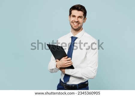 Young fun employee IT business man corporate lawyer wear classic formal shirt tie work in office hold clipboard with paper account documents isolated on plain pastel blue background studio portrait Royalty-Free Stock Photo #2345360905
