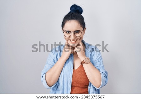 Young modern girl with blue hair standing over white background smiling with open mouth, fingers pointing and forcing cheerful smile 