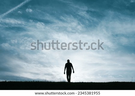 man silhouette feeling free among clouds in the mountain Royalty-Free Stock Photo #2345381955