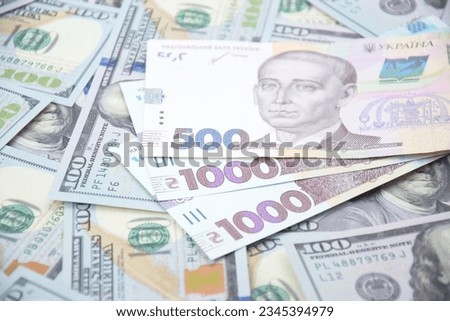 American dollars and Ukrainian hryvnia. The concept of the American aid to Ukraine in the war. The concept of the exchange rate.